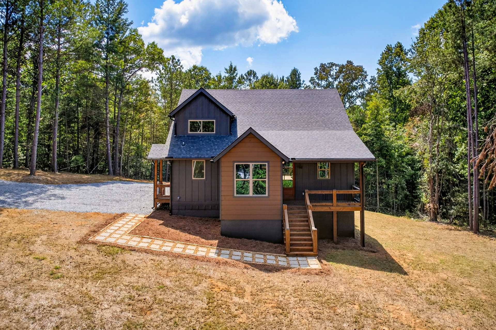 Front exterior of the two-story home with wood porch steps at 824 Banks Rd, Ellijay, GA