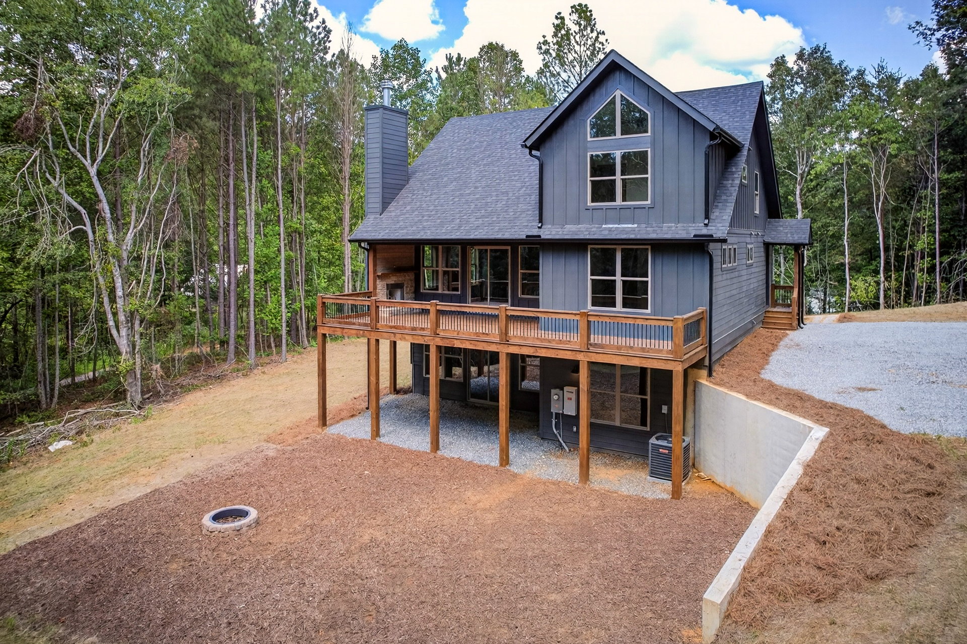 Back of the home with multi-level deck, patio, and fire pit at 824 Banks Rd, Ellijay, GA