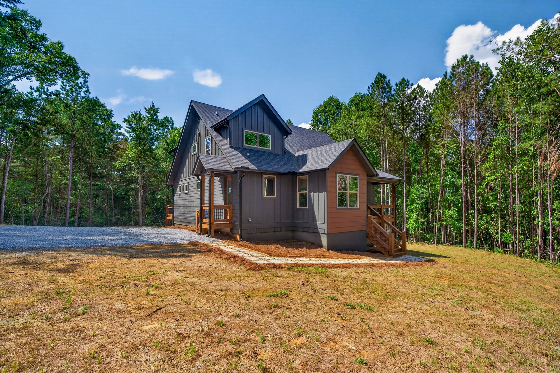 Distant side view of the home on a cleared lot in the woods at 824 Banks Rd, Ellijay, GA