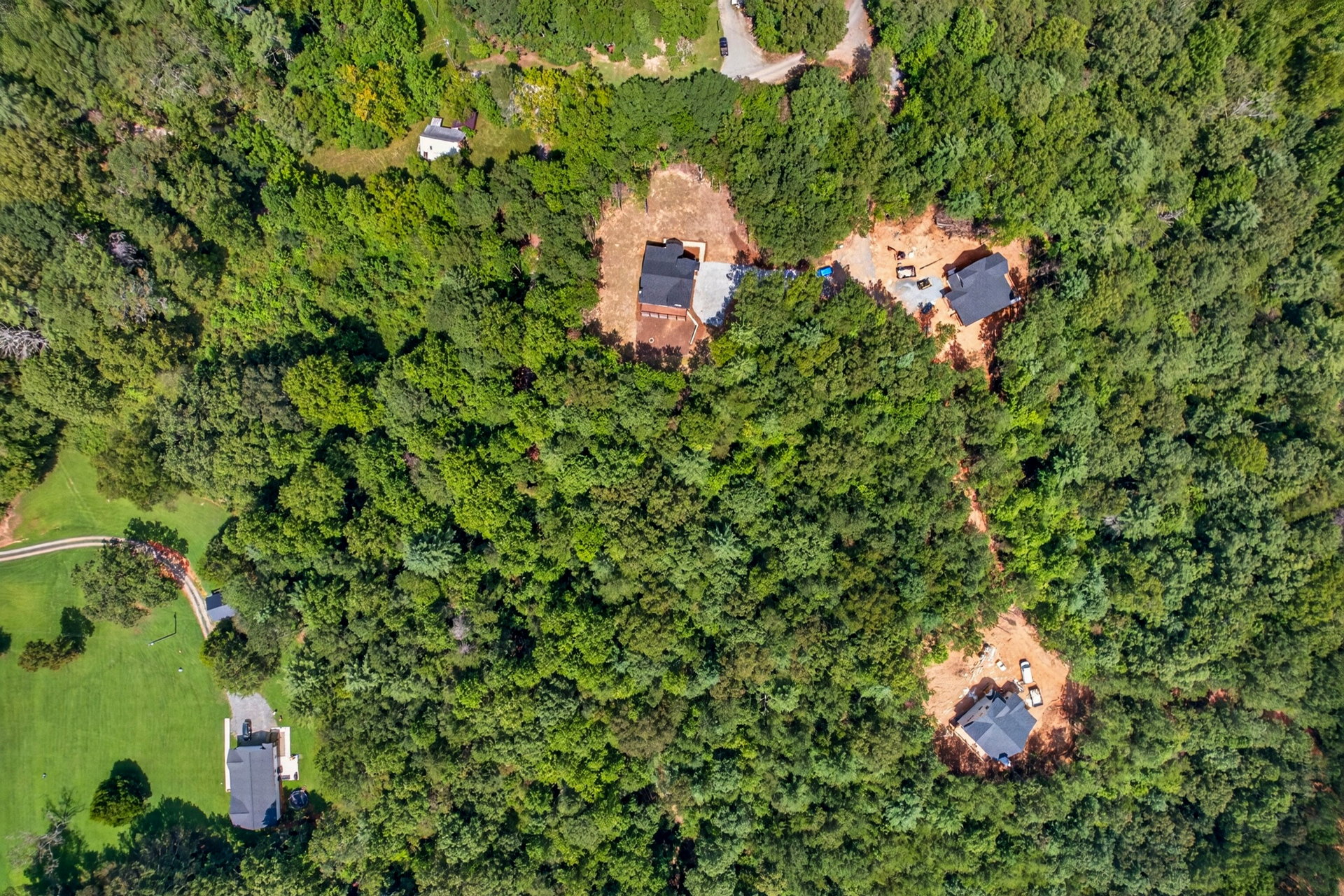 Aerial showing the home and nearby cleared lots in the forest at 824 Banks Rd, Ellijay, GA
