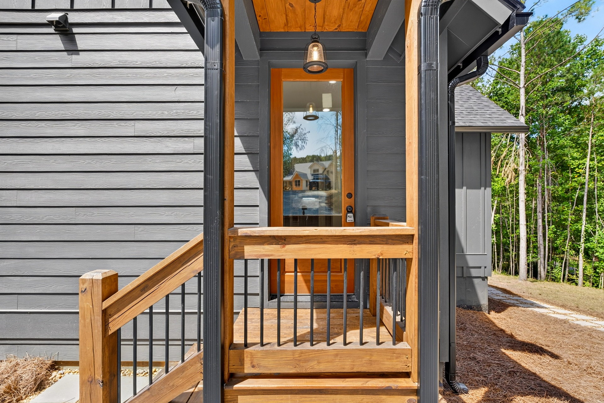 Covered porch entry with a glass-pane wood door at 824 Banks Rd, Ellijay, GA