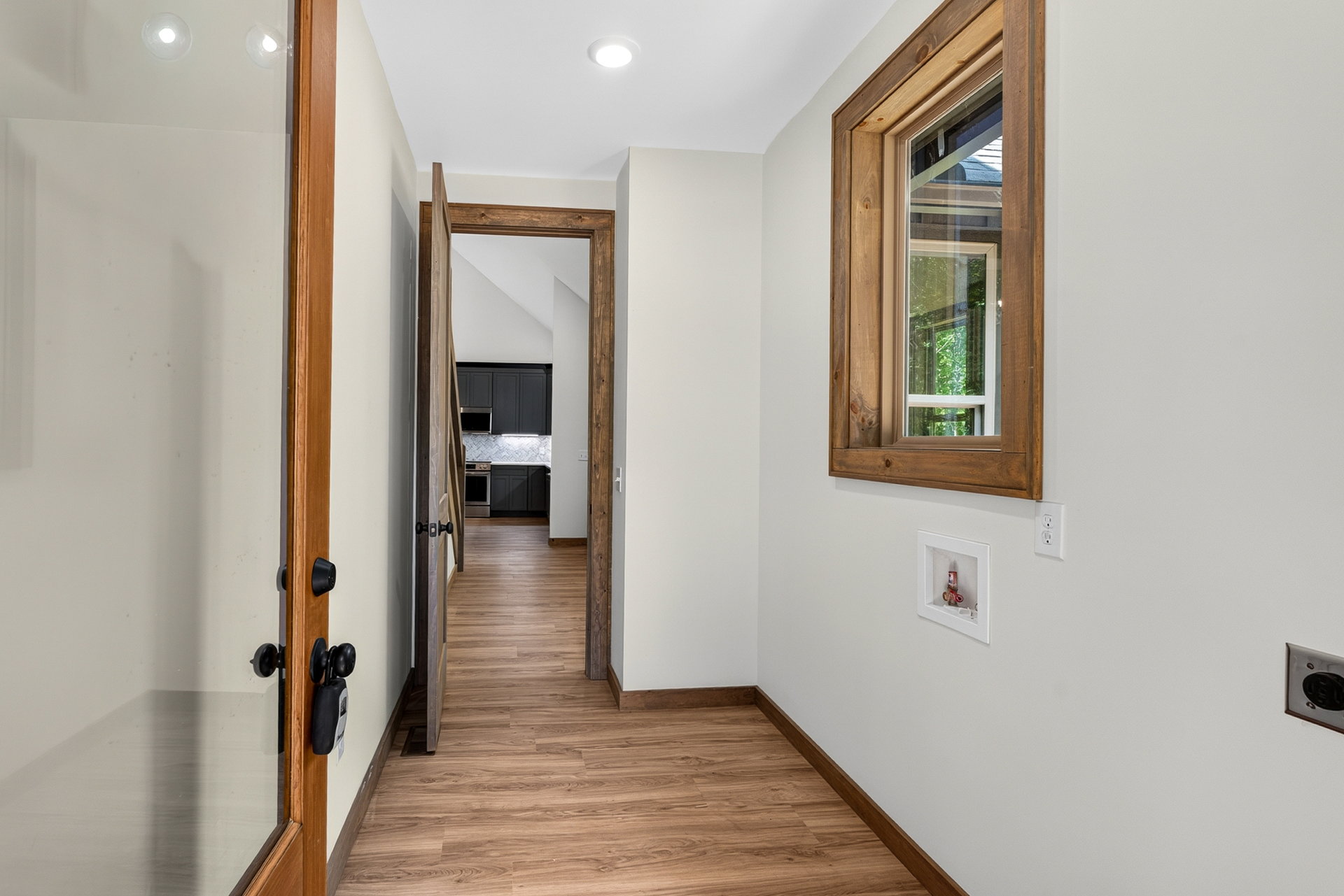 Interior hallway with wood floors and an open wood door at 824 Banks Rd, Ellijay, GA
