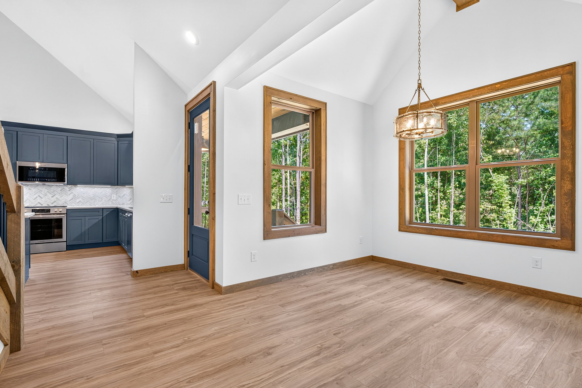 Open living and dining area with vaulted ceiling and chandelier at 824 Banks Rd, Ellijay, GA