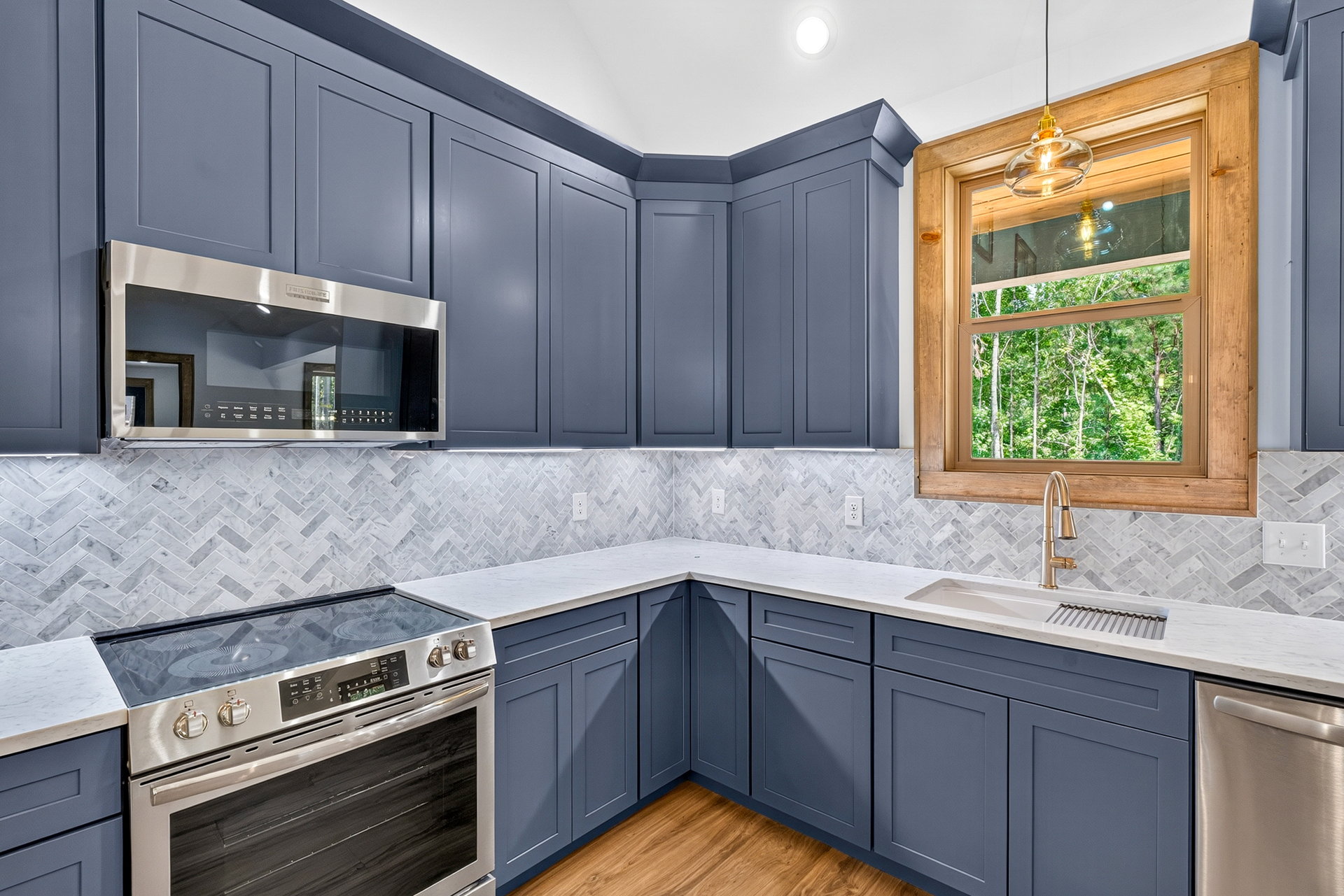Kitchen with dark cabinets, white stone counters, and stainless appliances at 824 Banks Rd, Ellijay, GA