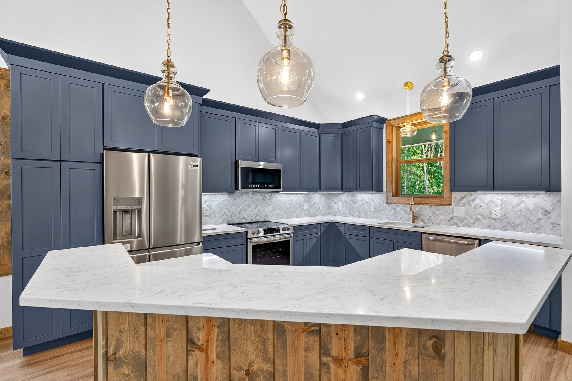 U-shaped kitchen with dark cabinets, wood island, and globe pendants at 824 Banks Rd, Ellijay, GA