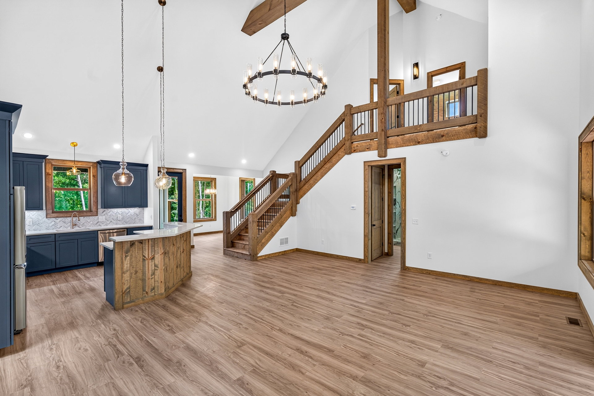 Kitchen looking across the living space to the wood staircase at 824 Banks Rd, Ellijay, GA