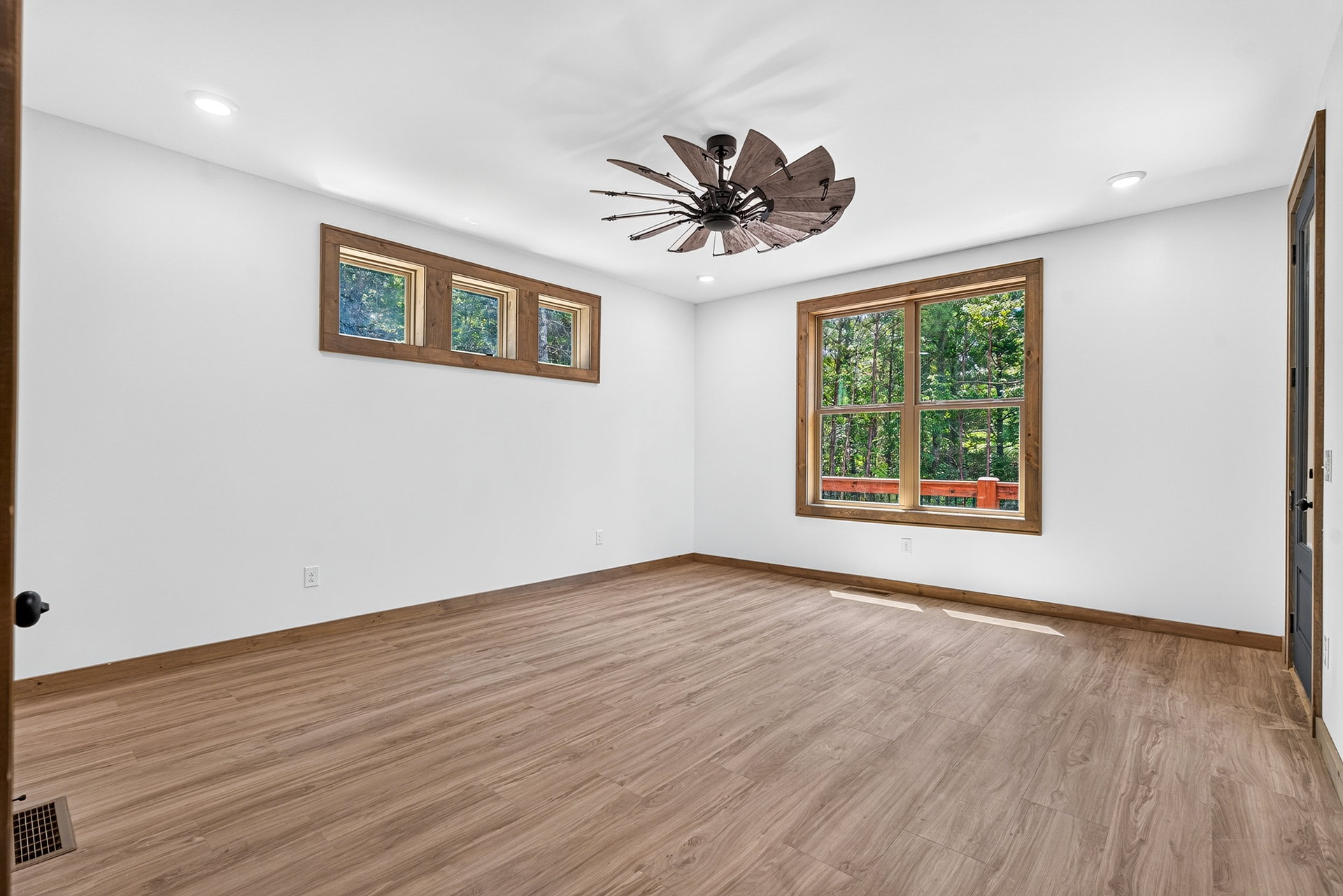 Bedroom with wood floors, mixed windows, and a ceiling fan at 824 Banks Rd, Ellijay, GA