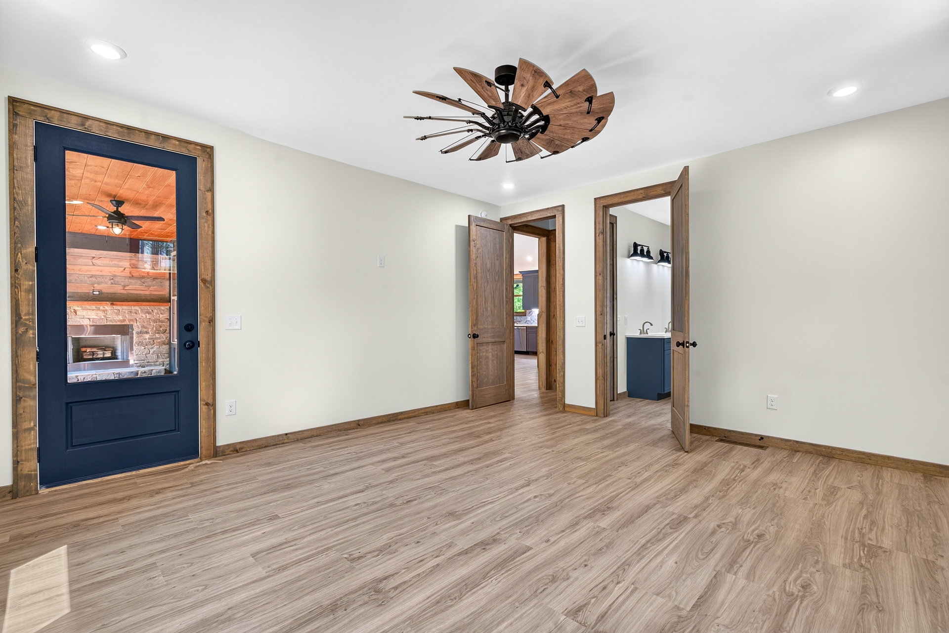 Bedroom showing a dark wood entry door and bath doorway at 824 Banks Rd, Ellijay, GA