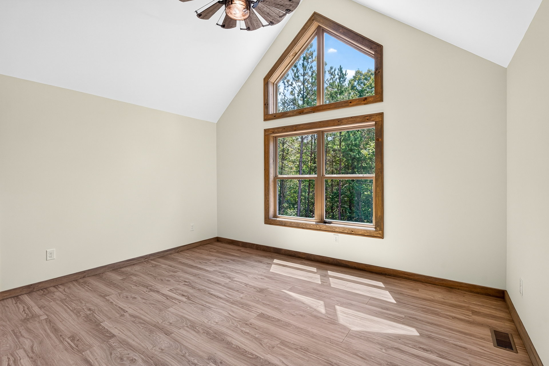 Bedroom with vaulted ceiling and large window at 824 Banks Rd, Ellijay, GA