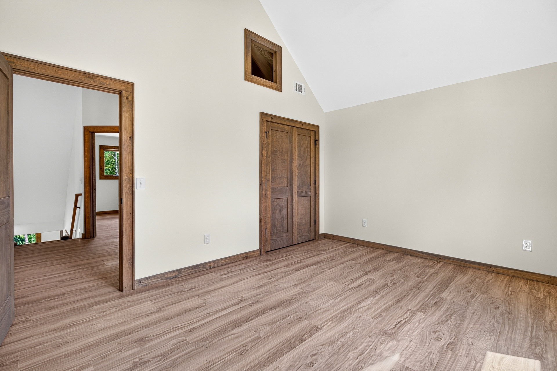 Bedroom showing two wood doors and light wood floors at 824 Banks Rd, Ellijay, GA