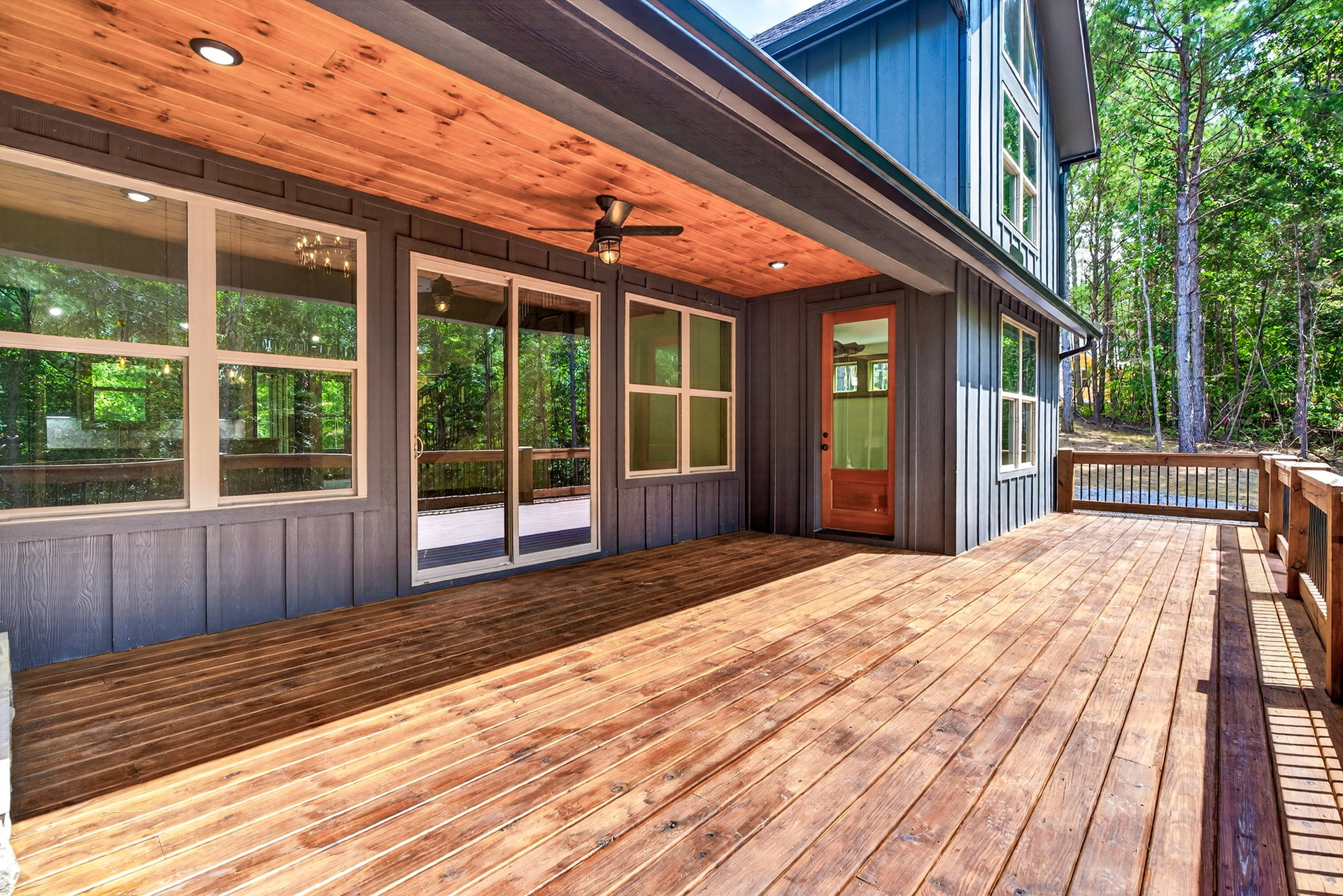 Covered wood deck with wood-paneled ceiling and glass door at 824 Banks Rd, Ellijay, GA