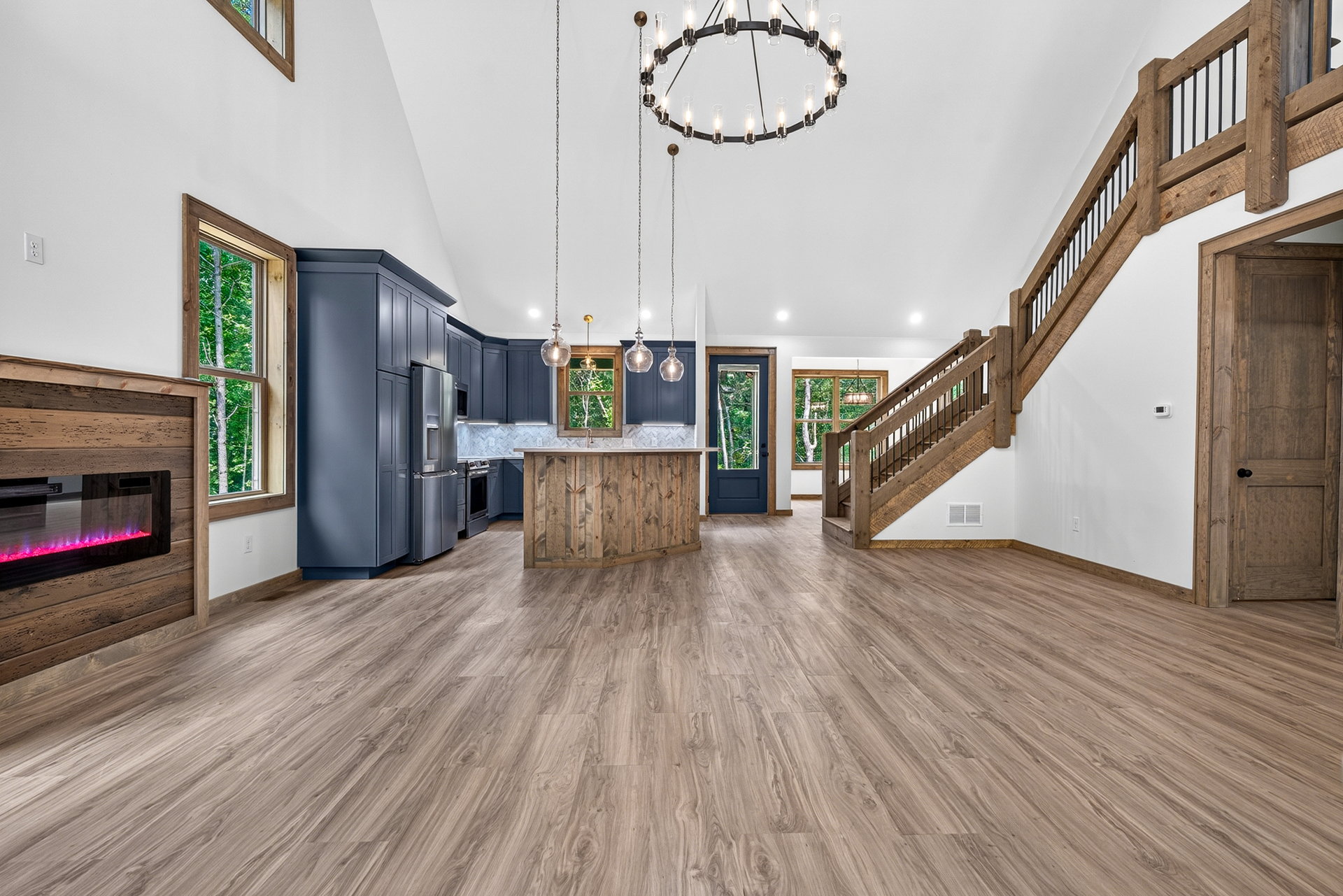 Open kitchen and living area with fireplace and staircase at 824 Banks Rd, Ellijay, GA