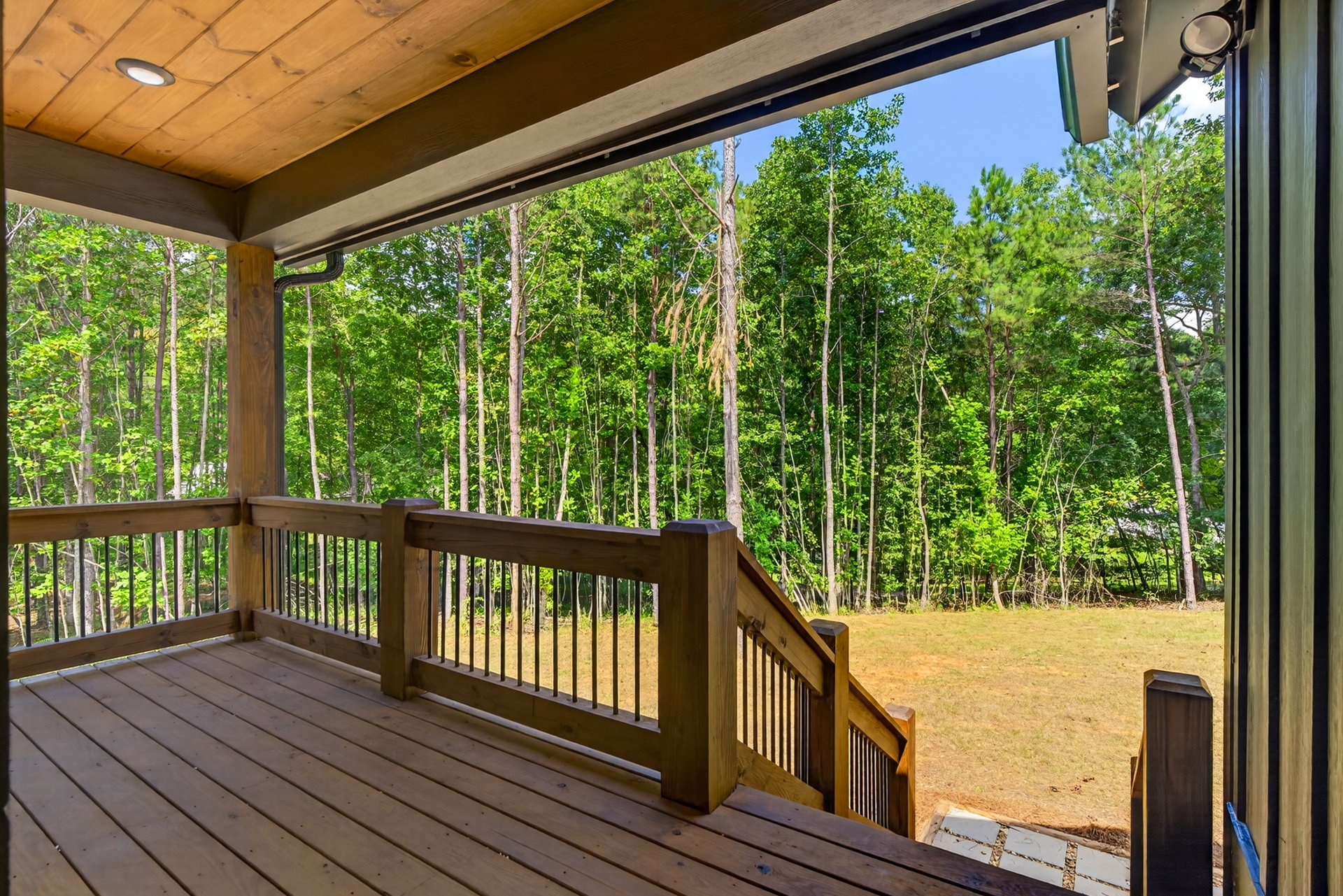 View from a wood doorway onto the deck and woods at 824 Banks Rd, Ellijay, GA