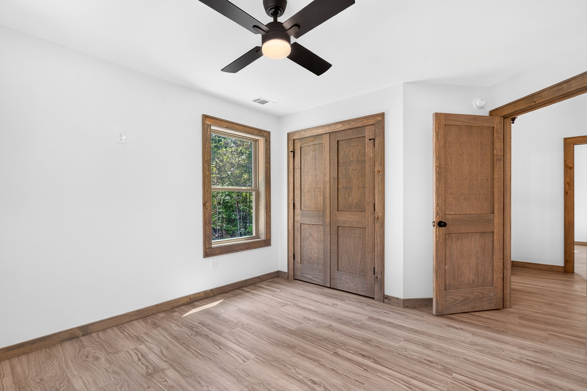 Bedroom with double wood closet doors at 824 Banks Rd, Ellijay, GA