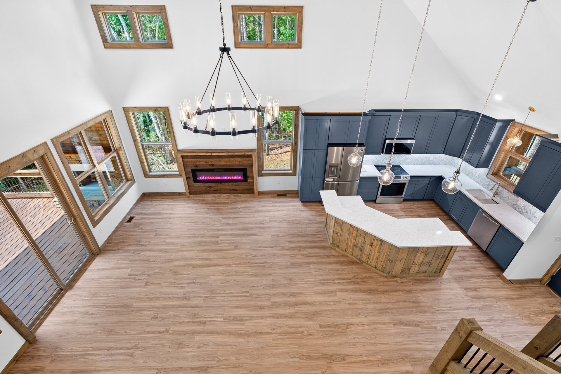 View down into the kitchen island, living area, and fireplace at 824 Banks Rd, Ellijay, GA