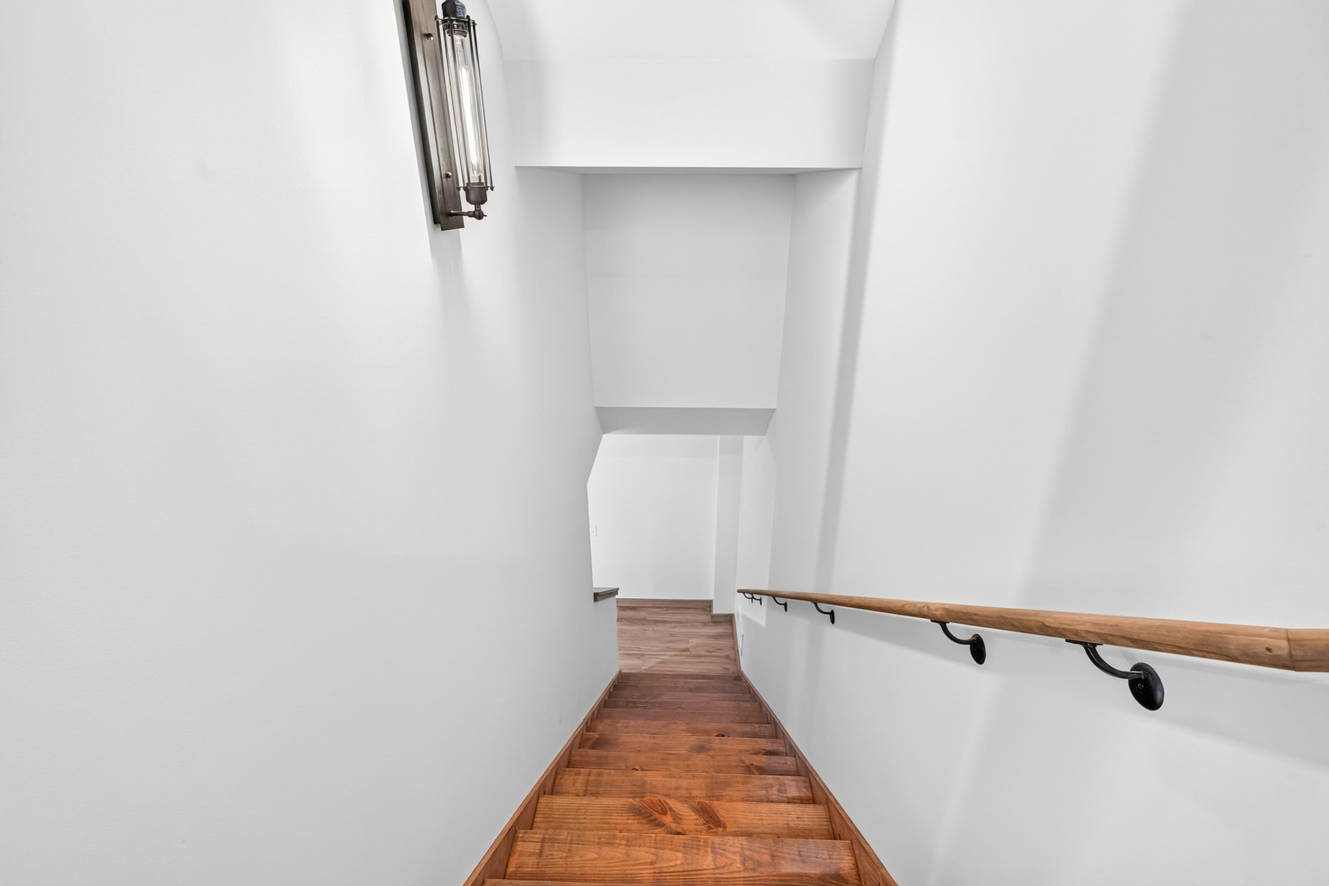 Narrow stairwell with white walls and a wood handrail at 824 Banks Rd, Ellijay, GA