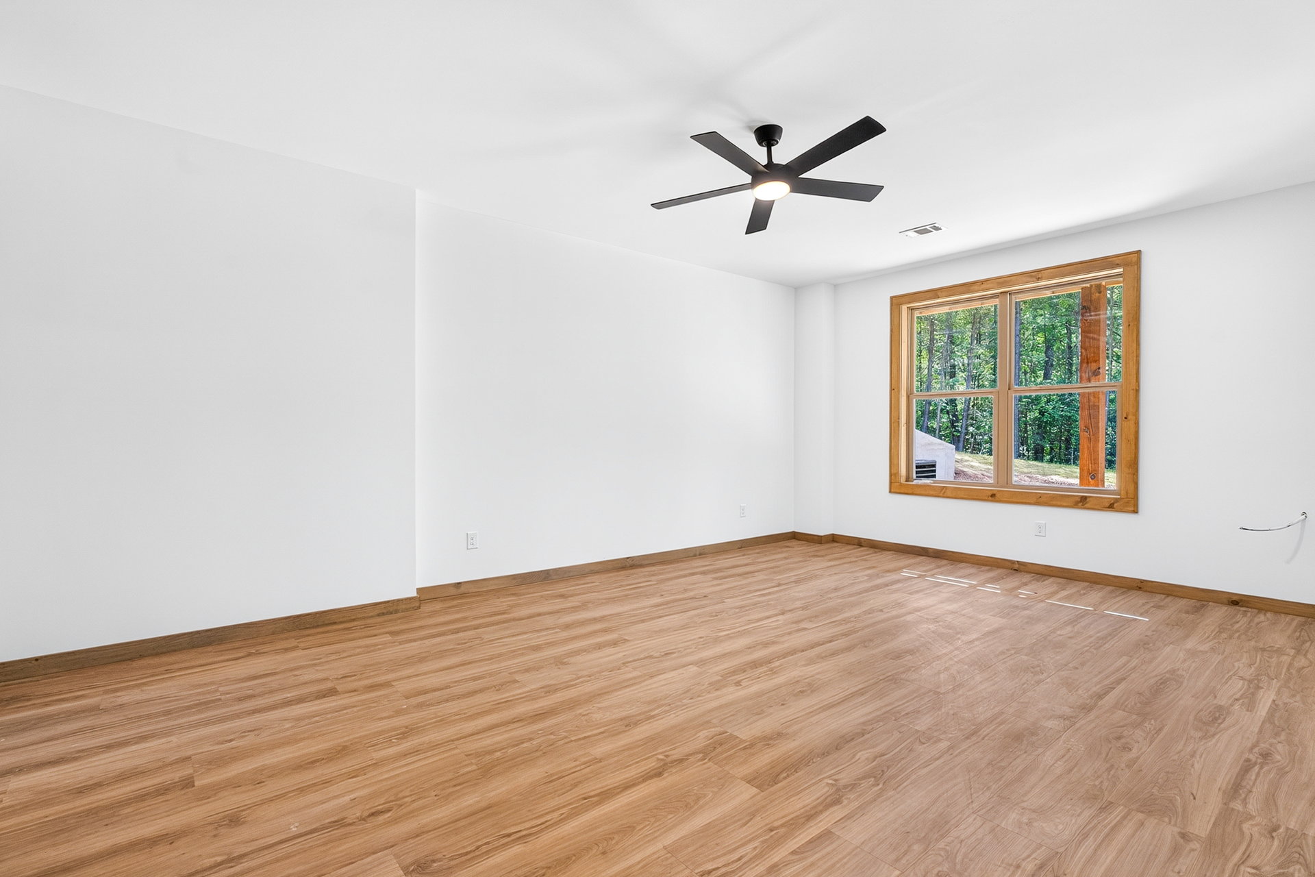 Bedroom with a wood-framed window and ceiling fan at 824 Banks Rd, Ellijay, GA