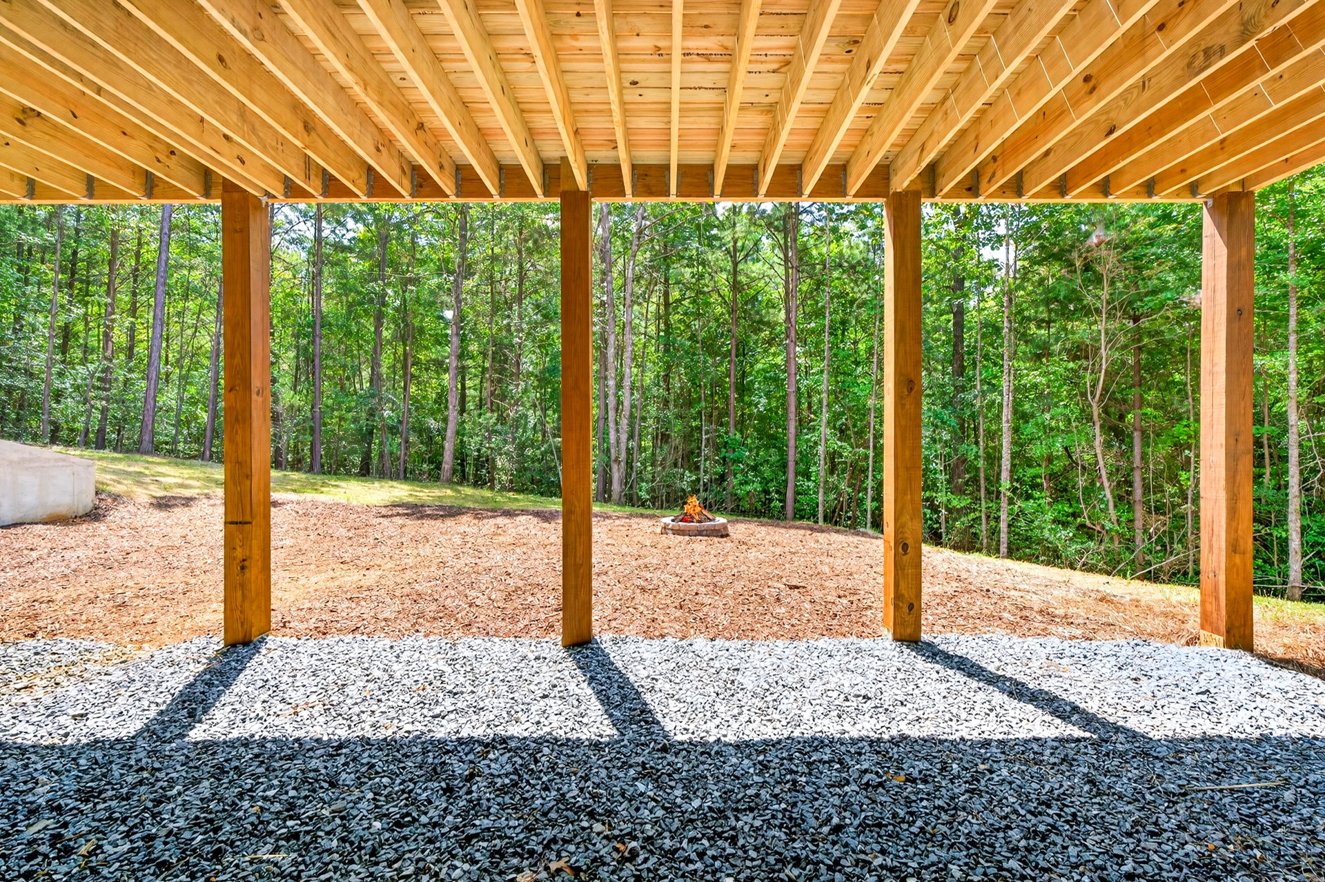 View from under the wood deck toward the yard at 824 Banks Rd, Ellijay, GA