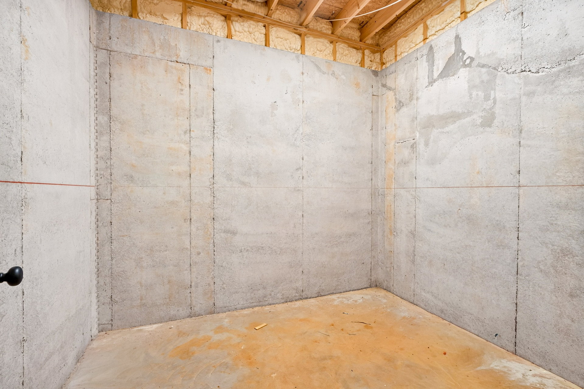 Unfinished basement with concrete walls and exposed floor joists at 824 Banks Rd, Ellijay, GA