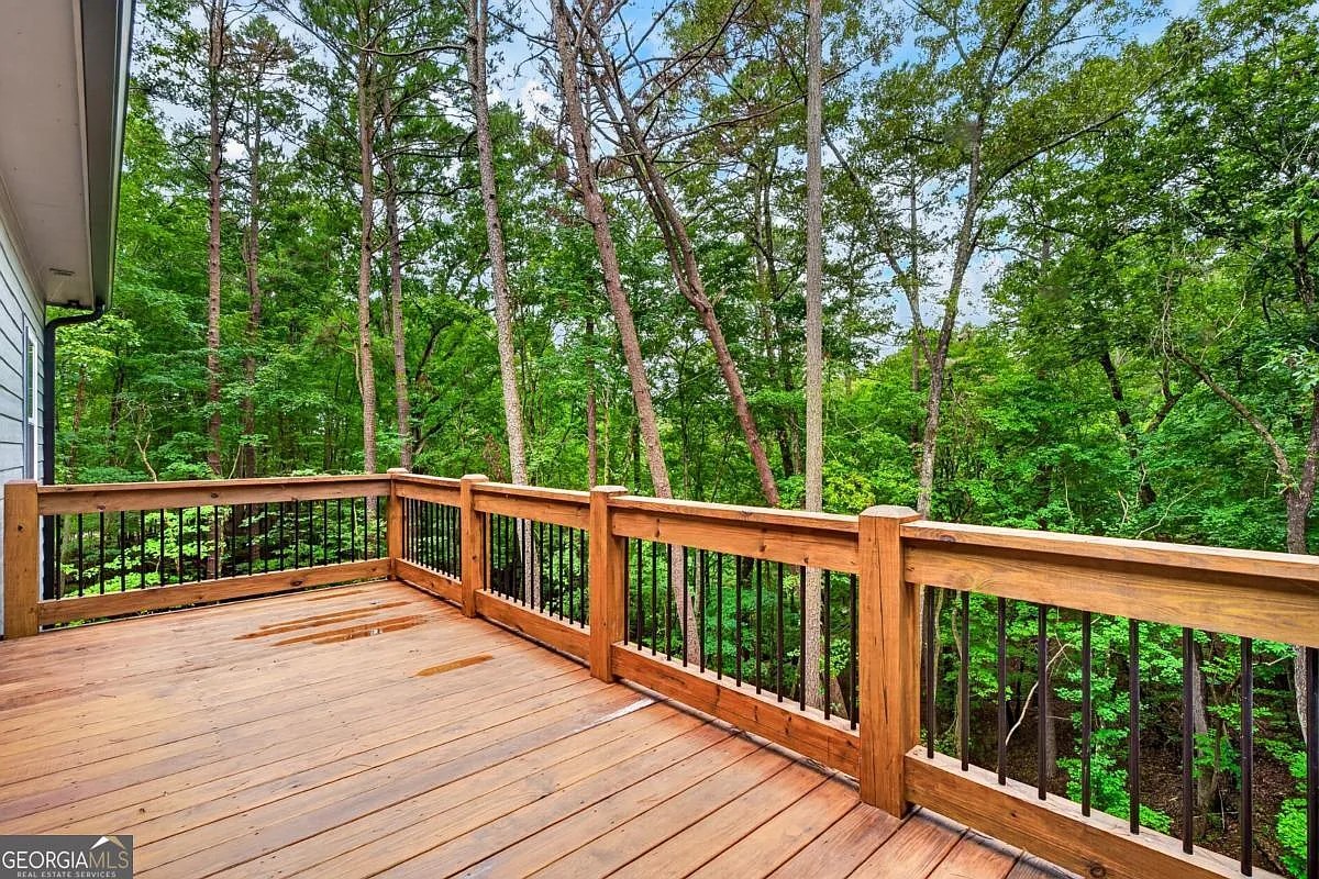 Wood deck with black-spindle railing looking into the woods at 579 Julep Circle, Ellijay, GA